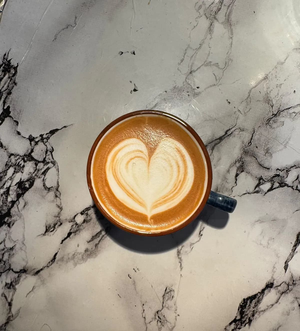 A latte with a layered heart.