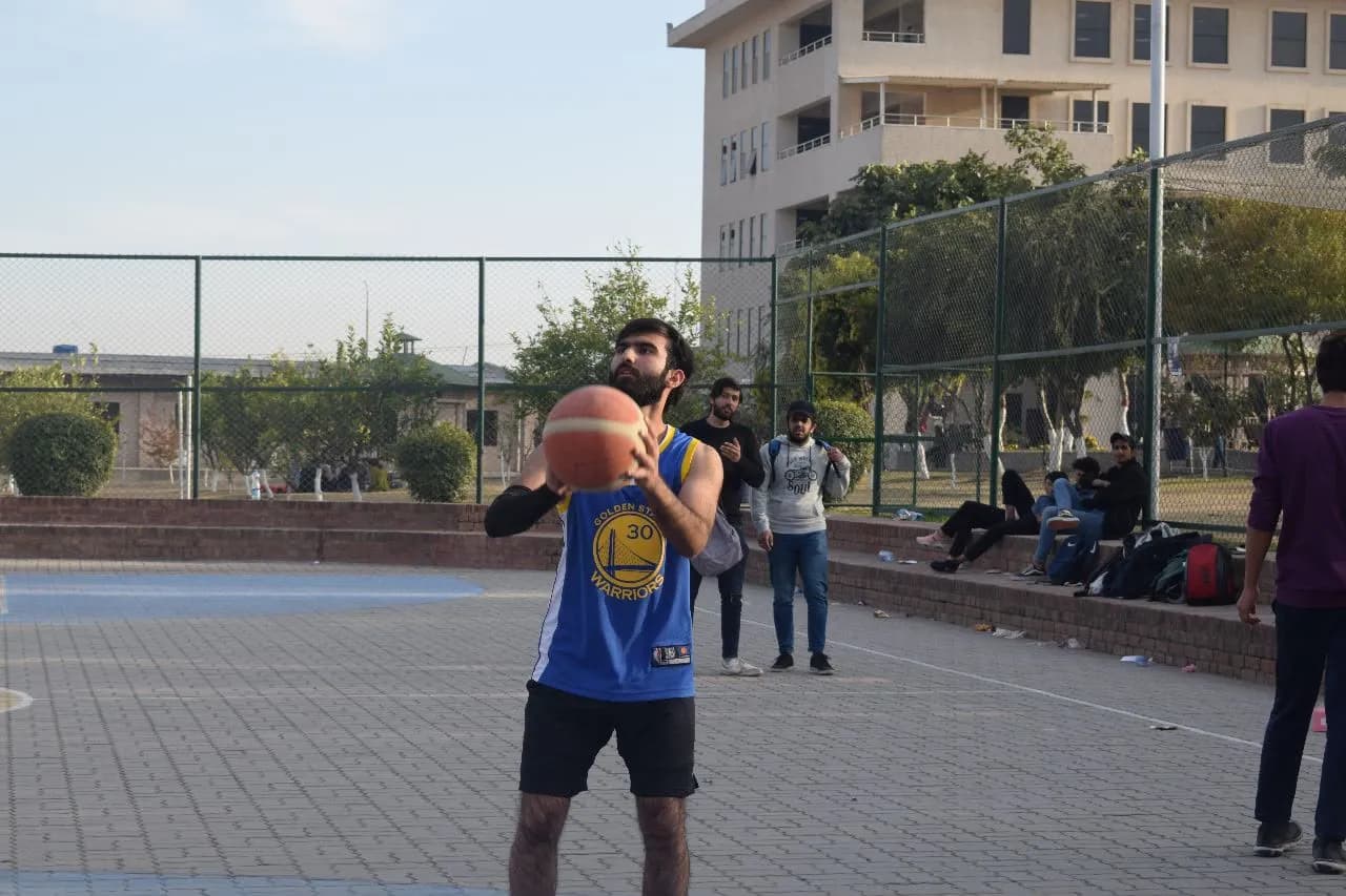Abdullah lining up a shot with the ball raised.